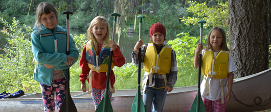 whispering-winds-girl-scouts-holding-canoe-paddles